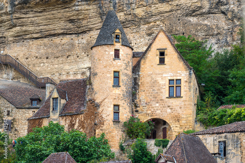 Historic architecture in La Roque-Gageac surrounded by natural cliffs and greenery photo