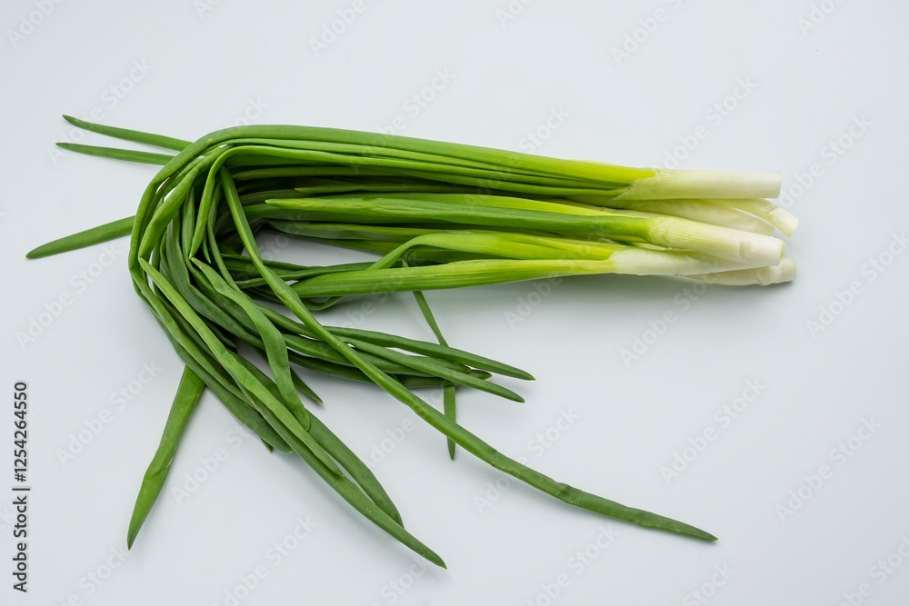 Fresh green onions on a white background. Healthy food. Fresh green onions on a white background. Healthy food.