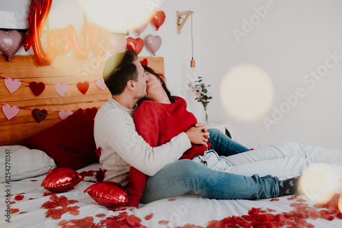 Romantic Couple on Valentine’s Day with Petals and Pet in Bedroom