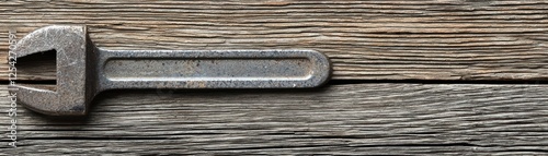 Rusty wrench on weathered wood background. Useful for tools, work, or DIY photo