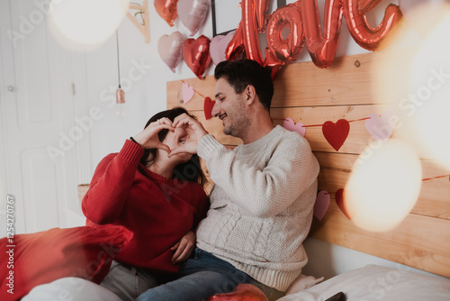 Romantic Couple on Valentine’s Day with Petals and Pet in Bedroom