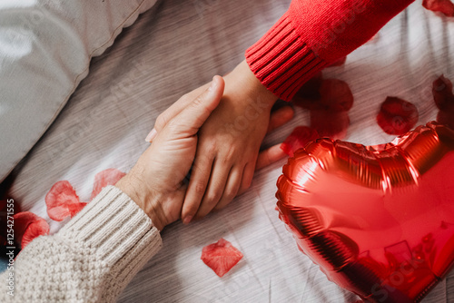 Romantic Couple Holding Hands in Bed