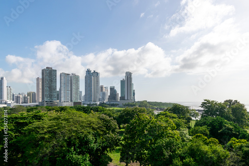 Panoramic view of the Panama City skyline and the Pacific Ocean; near the city, part of the Pan-American Highway is visible over the water.