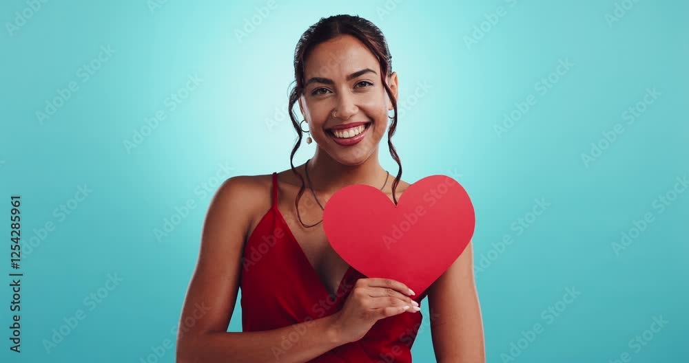 Woman, paper heart and smile in studio with choice, date or sign for valentines day by blue background. Girl, person and happy with icon, emoji and board for love, excited and decision in Colombia Woman, paper heart and smile in studio with choice, date or sign for valentines day by blue background. Girl, person and happy with icon, emoji and board for love, excited and decision in Colombia