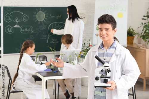 Teenage boy with microscope...