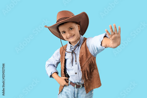Cute little cowboy waving h...