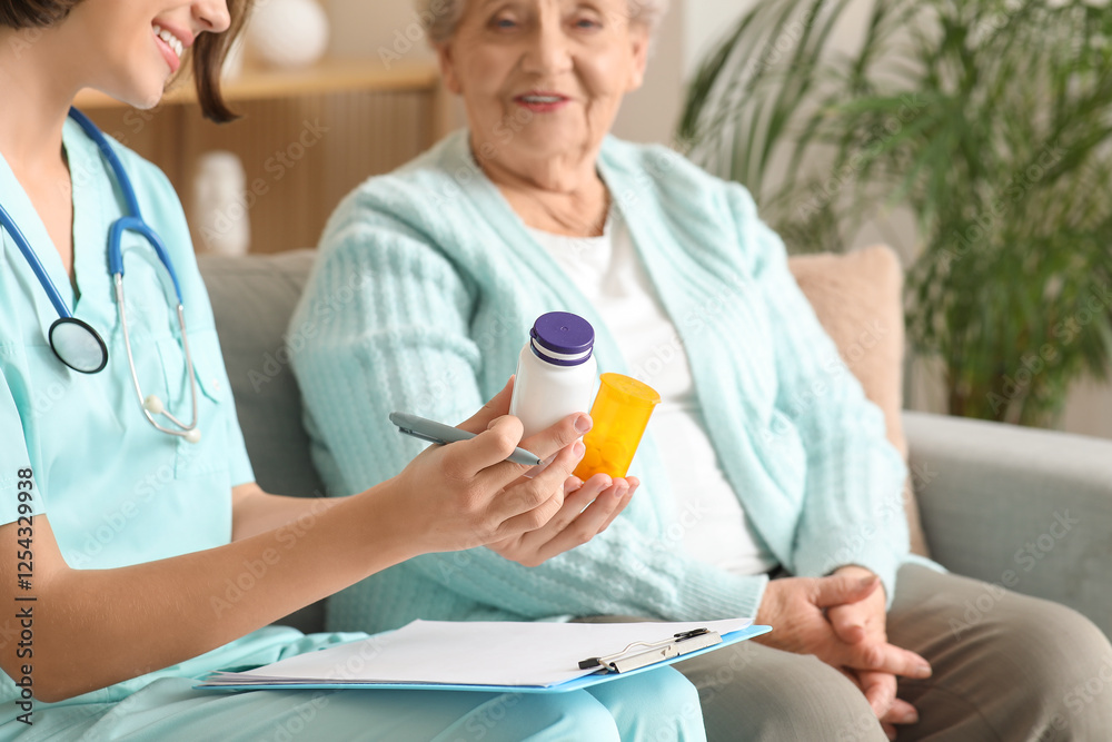 Young nurse prescribing pills to senior woman at home, closeup Young nurse prescribing pills to senior woman at home, closeup