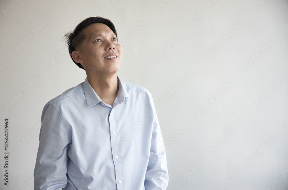Happy smiling Asian middel aged man looking up in positive, happy, smiling, hopeful, aiming at life goal mood or expression Happy smiling Asian middel aged man looking up in positive, happy, smiling, hopeful, aiming at life goal mood or expression