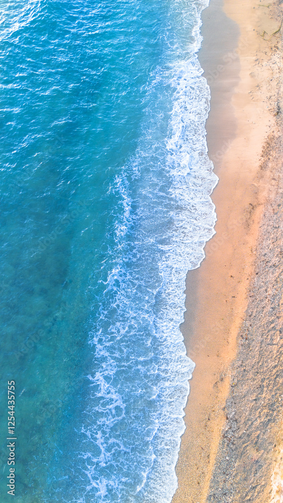 Obraz premium Aerial view of beautiful sandy beach and sea wave in summer time