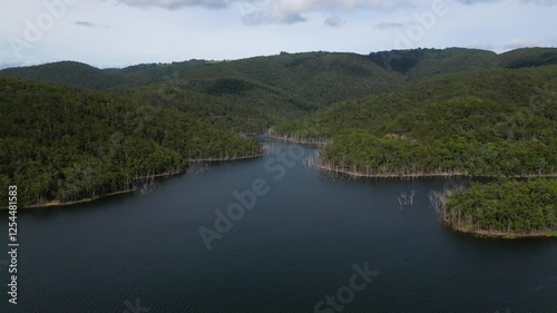 Right to left aerial views of Advancetown Lake near the Western Boat Ramp on the Gold Coast Hinterland. photo