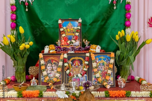 Decorations made with Hindu Religious Gods and garlands of flowers during a House warming ceremony
