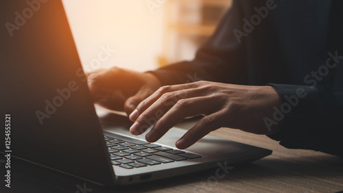 Closeup of businessman hand typing on laptop computer at office.  Business man working on computer device