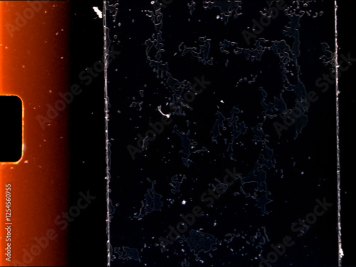 Damaged super 8 film showing dust, scratches and mold on film surface with sprocket holes photo