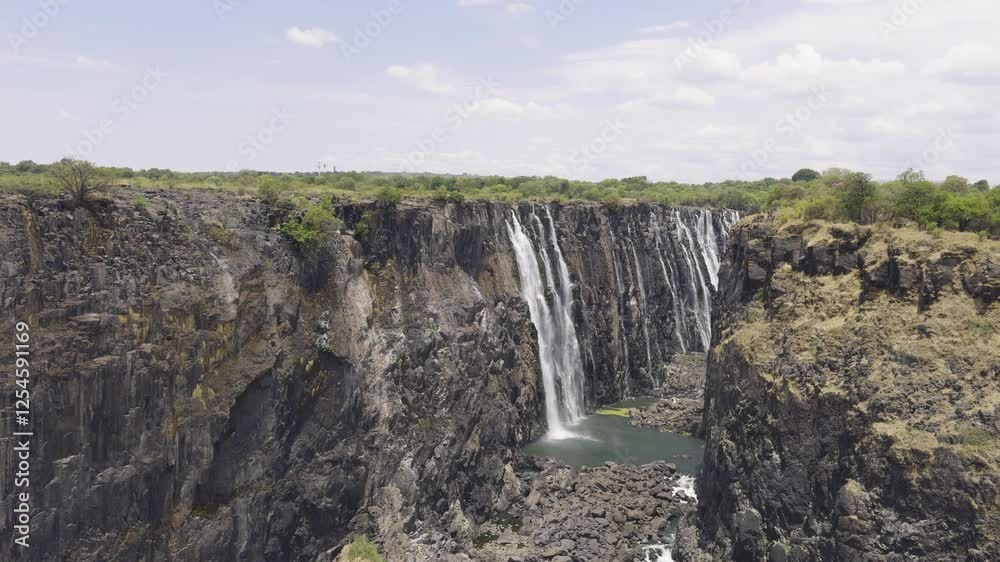 Majestic aerial view of Victoria Falls, showcasing the cascading waterfalls and surrounding nature Majestic aerial view of Victoria Falls, showcasing the cascading waterfalls and surrounding nature