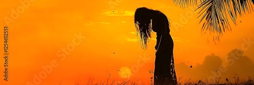 Silhouette of a vengeful Pontianak ghost a female vampiric spirit from Malaysian folklore lurking under a palm tree against a dramatic orange and dark sky at dusk photo