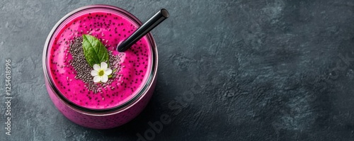 Vibrant and refreshing pink dragon fruit smoothie served in a glass jar topped with fresh mint leaves photo