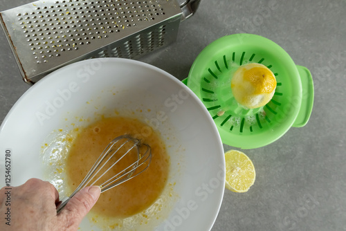 lemon cookie preparation with whisk and grater  
 photo