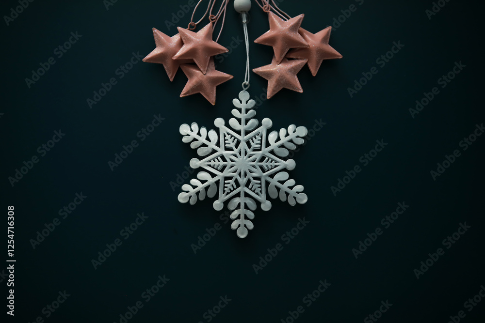 Fototapeta premium Elegant Pink Stars and White Snowflake Christmas Decoration Against Dark Background