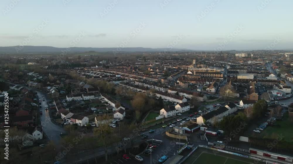 Aerial view of the Taunton in the United Kingdom after a rainy night. Roof top view of the residential estates. Drone moving forward over the houses and busy streets. Church in the background. Aerial view of the Taunton in the United Kingdom after a rainy night. Roof top view of the residential estates. Drone moving forward over the houses and busy streets. Church in the background.