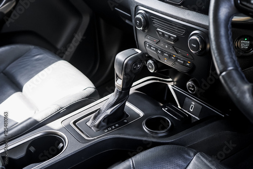 automatic transmission shift selector in the car interior. Closeup a manual shift of modern car gear shifter. 4x4 gear shift.