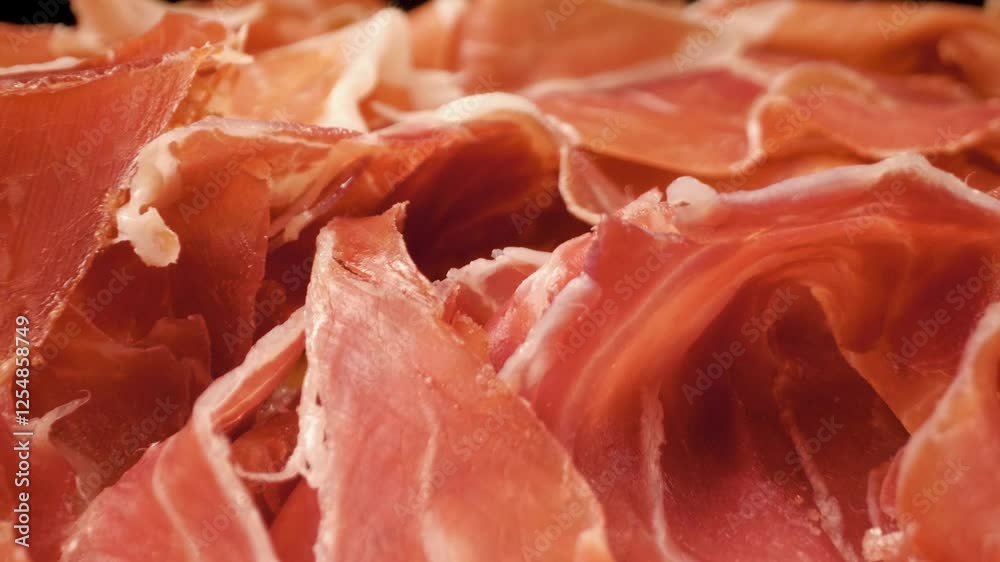 Spanish Jamon Iberico sliced. Slider movement. Close-up Spanish Jamon Iberico sliced. Slider movement. Close-up