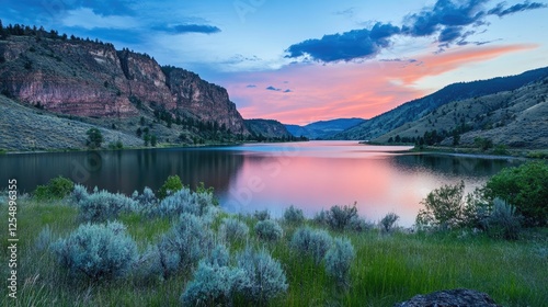 Tranquil lake nestled in a mountain valley at dusk