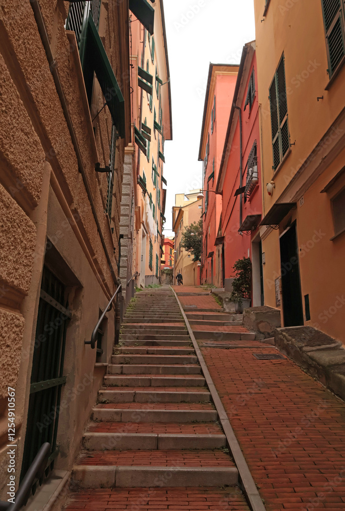 Fototapeta premium Traditional buildings and steps, pedestrianized narrow streets of old town. Genoa and medieval architecture of Italy. Windows and doors.