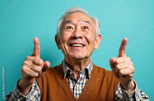 Older man with gray hair expresses joy while pointing in a bright turquoise background setting