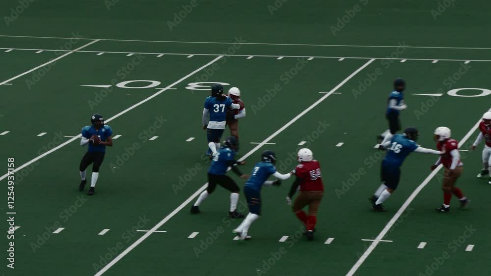 Two Athletic Teams Take Their Positions at The Start of a Football Game. The Ball Is Snapped and the Player Runs Forward While The Opposing Team Attempts To Stop Him in Front of a Crowded Stadium Two Athletic Teams Take Their Positions at The Start of a Football Game. The Ball Is Snapped and the Player Runs Forward While The Opposing Team Attempts To Stop Him in Front of a Crowded Stadium