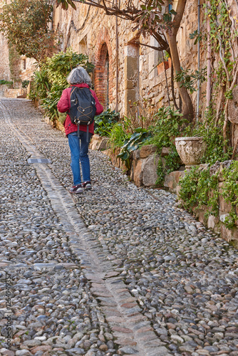 Obraz na płótnie Woman walking. Cobblestone street. Tossa de Mar. Girona. Spain w salonie