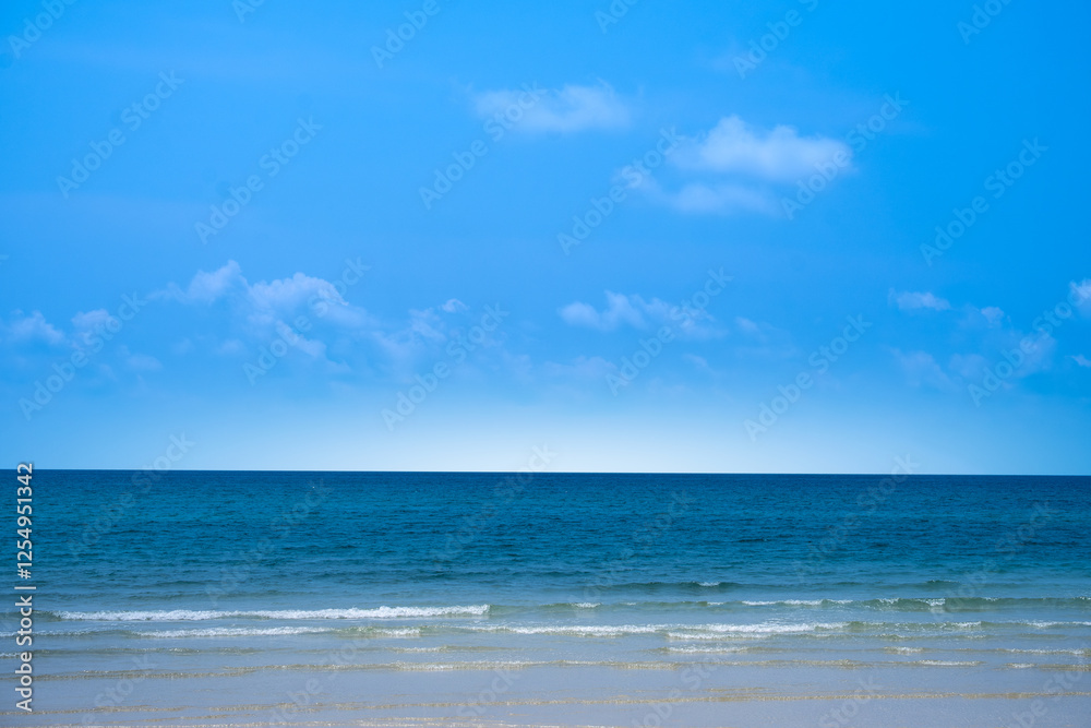 Nature of the beach and sea Summer with sunshine, sandy beaches, clear blue waters sparkling against the blue sky. On an island with good ecology and environment Background for summer vacation Nature of the beach and sea Summer with sunshine, sandy beaches, clear blue waters sparkling against the blue sky. On an island with good ecology and environment Background for summer vacation