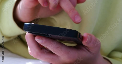 young woman using mobile phone at home freelance work