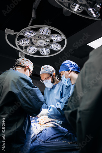A team of professional surgeons performs surgery in a modern hospital. Concept skills working using the latest technology in cardiology and transplantation.