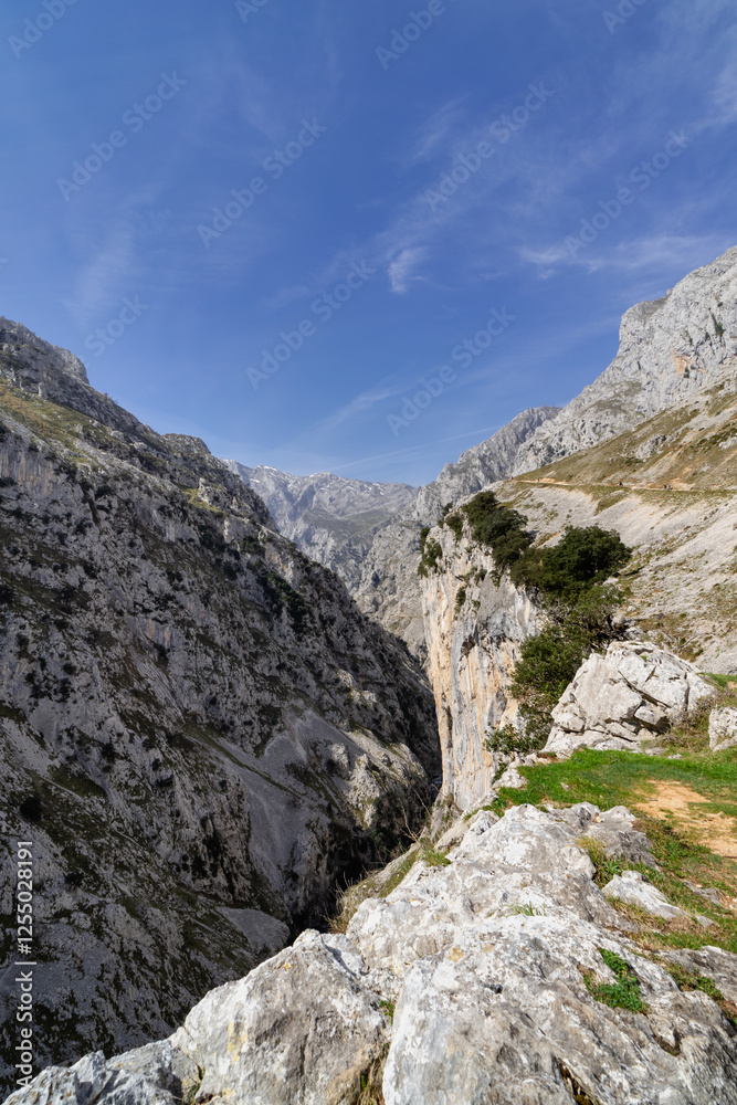 A mountain range with a clear blue sky. The mountains are covered in snow and the sky is bright and clear A mountain range with a clear blue sky. The mountains are covered in snow and the sky is bright and clear