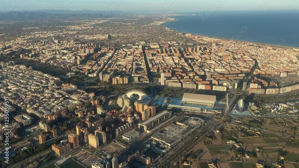 Aerial view of Valencia City center and norther coast recorded from an airplane cockpit during the arrival to the airport at the golden hour. 4K
