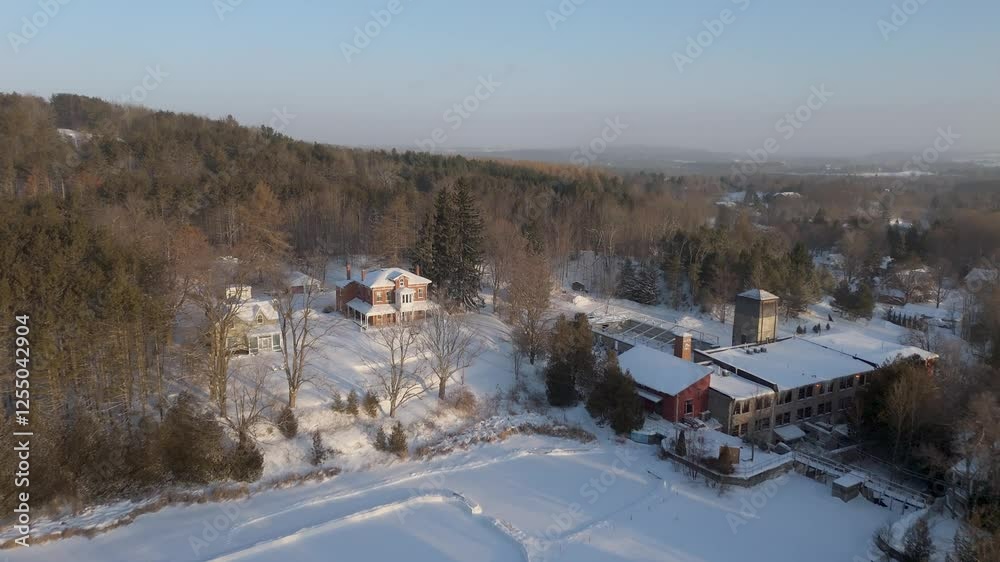 Skating Rink On A Pond At The Alton Mill At Sunrise During Winter In Ontario, Canada. Aerial Flyover. Skating Rink On A Pond At The Alton Mill At Sunrise During Winter In Ontario, Canada. Aerial Flyover.