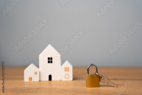 Padlock and wooden houses. Security concept. Insurance. Security and alarm systems, video surveillance, motion and burglary sensors.
