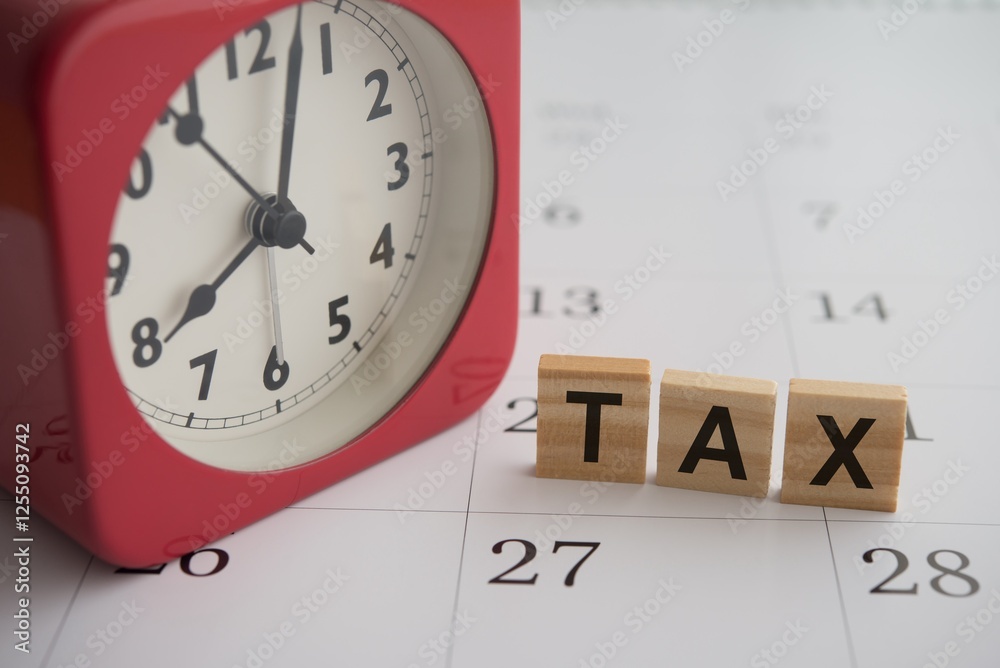 Red alarm clock and TAX alphabet on blank white calendar background. Tax payment schedule and management, taxation, financial planning concept. Red alarm clock and TAX alphabet on blank white calendar background. Tax payment schedule and management, taxation, financial planning concept.