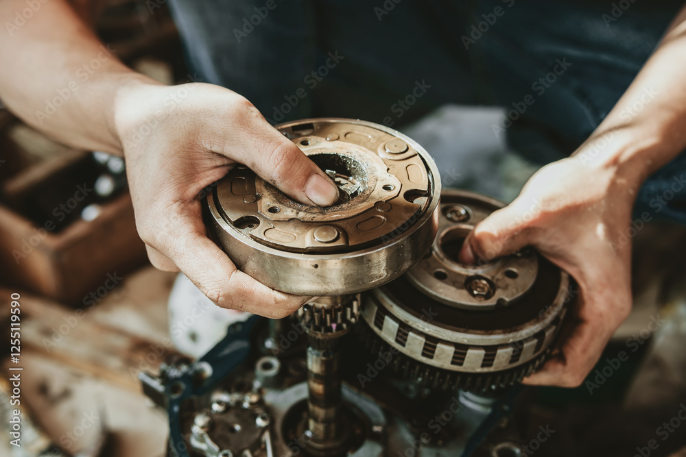 Motorcycle Engine Rebuild, Motorcycle mechanic repairing gearbox,working at garage, maintenance and repair motorcycle concept