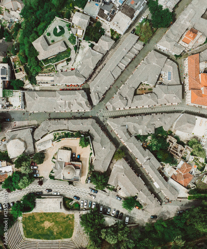 Aerial drone view of old quarters of Gjirokaster, Albania. Traditional houses in the old city of Gjirokaster. UNESCO World Heritage Site.
