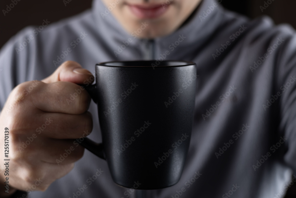Men hold black cup in hands close up Men hold black cup in hands close up