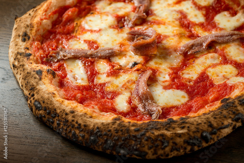 romana pizza, with tomato mozzarella and anchovy