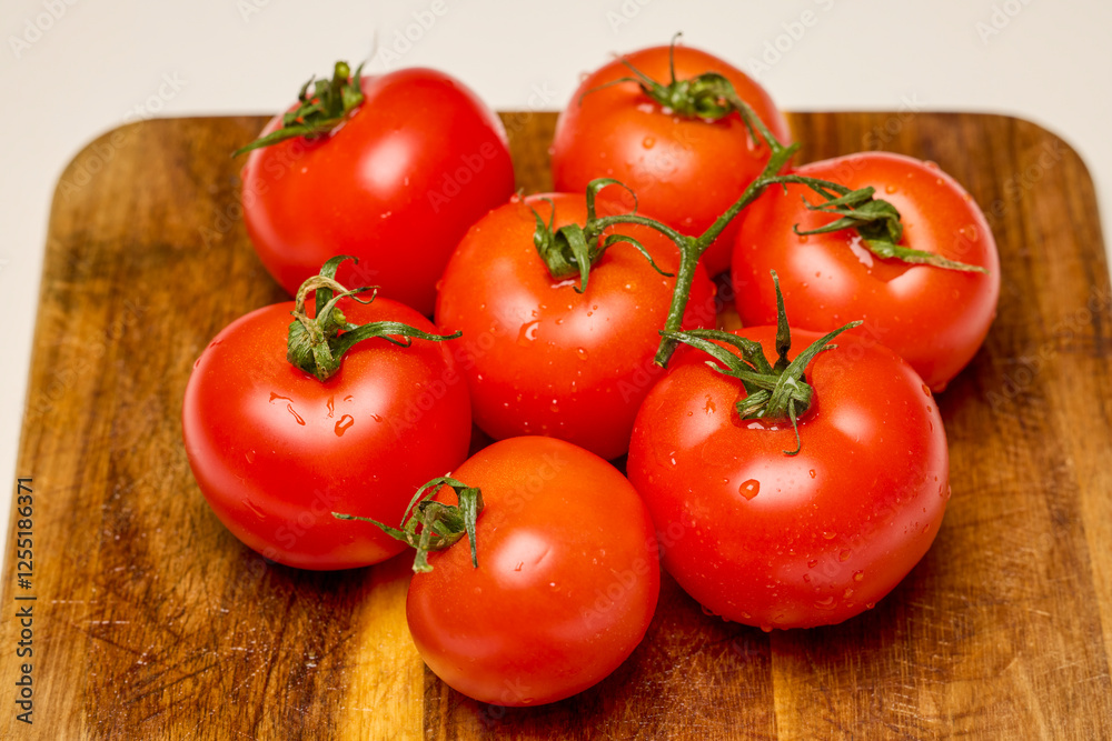 fresh tomatoes on a wooden chopping board fresh tomatoes on a wooden chopping board