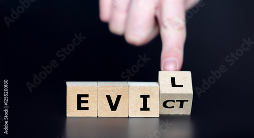 Quadro su tela Hand turns cube and changes the word evict to evil