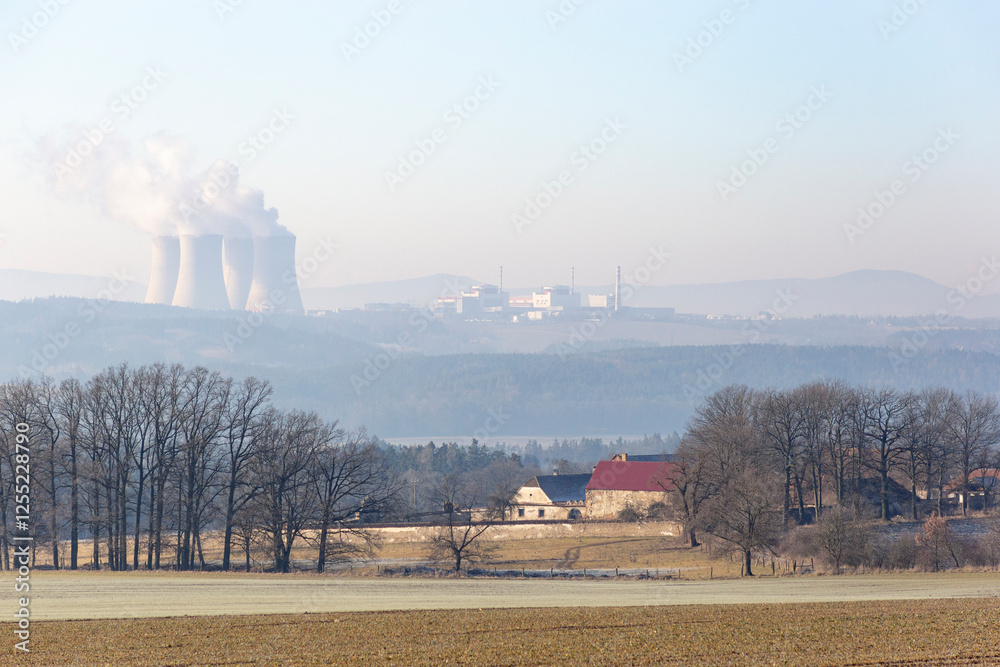 A farmhouse in southern Czechia and the Temelin Nuclear Power Plant on the horizon. Cold winter morning.