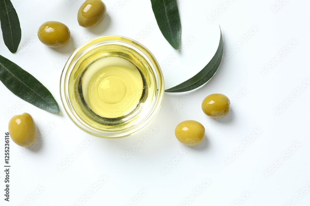 Bowl of fresh olive oil and olives with leaves on white background Bowl of fresh olive oil and olives with leaves on white background