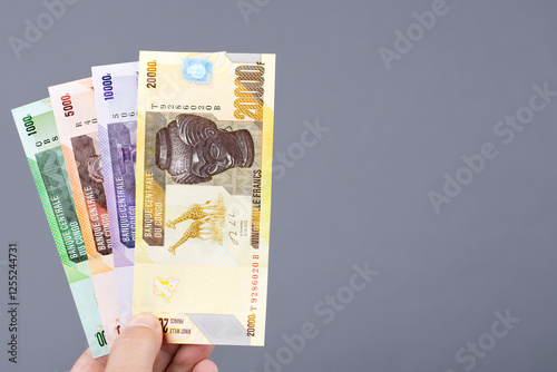 Congolese money in the hand on a gray background photo