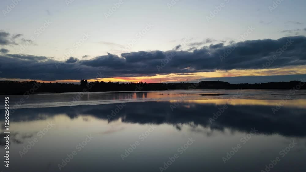 Aerial Drone Shot of Stokkavannet Lake at Winter Sunset with Silhouetted Reflections Aerial Drone Shot of Stokkavannet Lake at Winter Sunset with Silhouetted Reflections