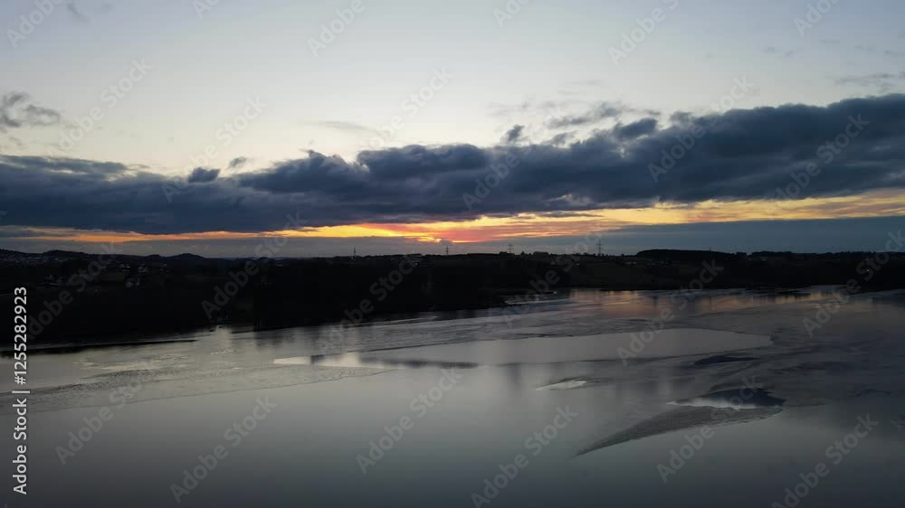 Aerial Drone Shot of Stokkavannet Lake at Winter Sunset with Silhouetted Reflections Aerial Drone Shot of Stokkavannet Lake at Winter Sunset with Silhouetted Reflections