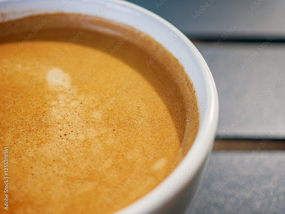 Coffee cream texture of fragrant coffee in a cup with delightful coffee colored bubbles with foam. macro coffee crema Coffee cream texture of fragrant coffee in a cup with delightful coffee colored bubbles with foam. macro coffee crema